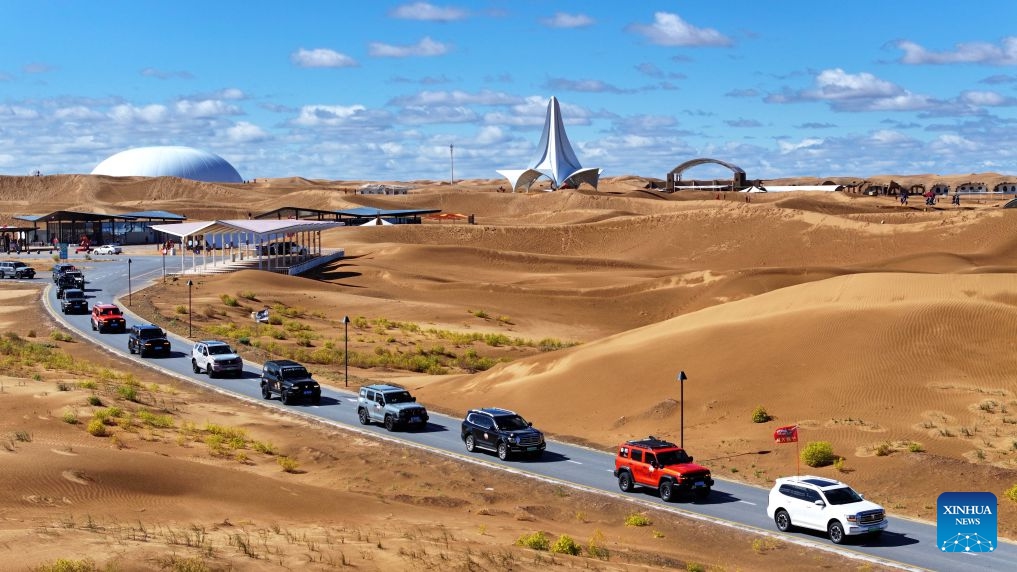 An aerial drone photo taken on Oct. 17, 2026 shows vehicles driving at the Shapotou scenic area in Zhongwei, northwest China's Ningxia Hui Autonomous Region. Marking the beginning of a desert self-driving event, a ceremony was held here on Saturday, gathering more than 500 vehicles for self-driving tours and over 1,000 tourists. (Xinhua/Wang Peng)