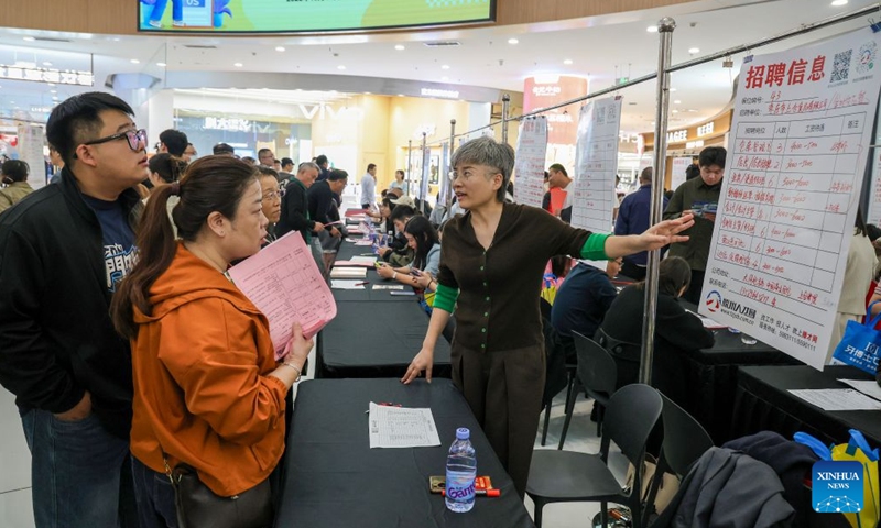 An employer explains job information to jobseekers at a job fair in Tengzhou, east China's Shandong Province, Oct. 17, 2026. Job fairs are held in various cities across China, connecting jobseekers with potential employers and creating opportunities for both. (Photo by Song Haicun/Xinhua)