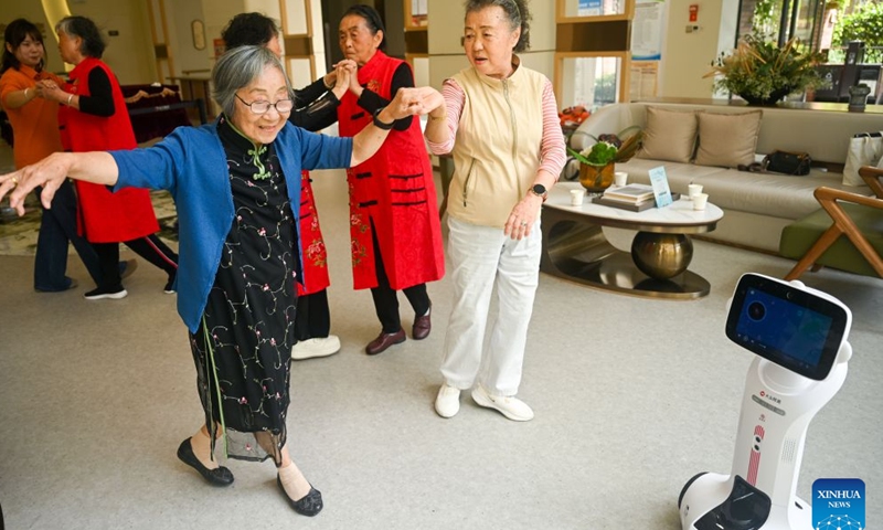 The elderly dance at a senior care facility in Wudang District of Guiyang, southwest China's Guizhou Province, Oct. 16, 2026. In recent years, Guizhou has been continuously improving its elderly care service system, with many places upgrading community-based elderly care service stations to provide heartwarming services such as community meal aid, free health consultations, and cultural and recreational activities. (Photo by Yuan Fuhong/Xinhua)