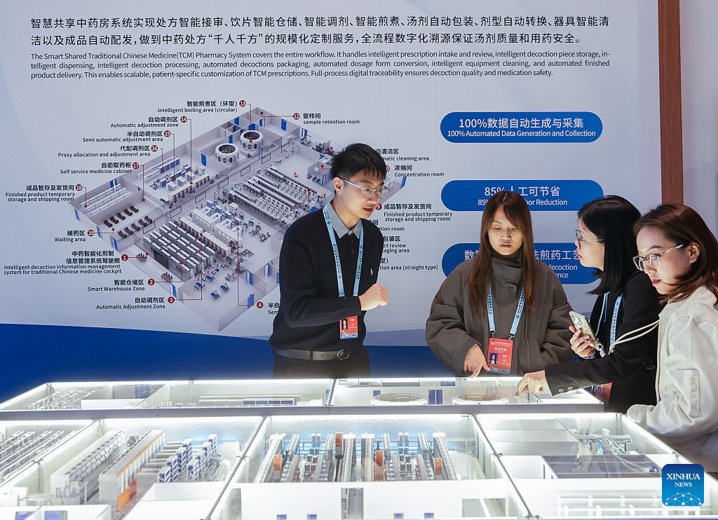 A staff member introduces the Smart Shared Traditional Chinese Medicine (TCM) Pharmacy System to guests during World Conference on Traditional Medicine 2026 in Beijing, capital of China, Oct. 17, 2026. Guests from home and abroad have gathered together to experience and feel the charm of Traditional Chinese Medicine (TCM) during World Conference on Traditional Medicine 2026 and the Beijing International Traditional Healthcare Exhibition, which kicked off here on Saturday and Friday respectively. (Xinhua/Zhang Yuwei)

