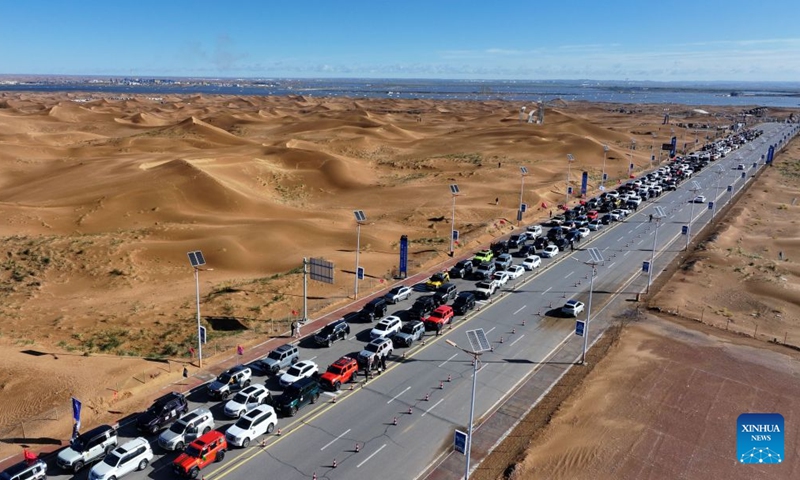 An aerial drone photo taken on Oct. 17, 2026 shows vehicles gathering at the Shapotou scenic area in Zhongwei, northwest China's Ningxia Hui Autonomous Region. Marking the beginning of a desert self-driving event, a ceremony was held here on Saturday, gathering more than 500 vehicles for self-driving tours and over 1,000 tourists. (Xinhua/Wang Peng)