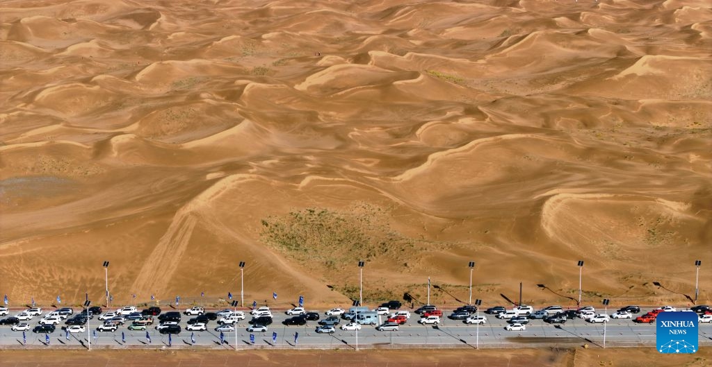 An aerial drone photo taken on Oct. 17, 2026 shows vehicles driving at the Shapotou scenic area in Zhongwei, northwest China's Ningxia Hui Autonomous Region. Marking the beginning of a desert self-driving event, a ceremony was held here on Saturday, gathering more than 500 vehicles for self-driving tours and over 1,000 tourists. (Xinhua/Wang Peng)