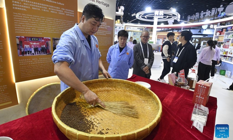 Technicians from Tongrentang, a leading Traditional Chinese Medicine (TCM) producer and retailer in China, demonstrate hand-made pharmaceutical skills during the Beijing International Traditional Healthcare Exhibition in Beijing, capital of China, Oct. 17, 2026. Guests from home and abroad have gathered together to experience and feel the charm of Traditional Chinese Medicine (TCM) during World Conference on Traditional Medicine 2026 and the Beijing International Traditional Healthcare Exhibition, which kicked off here on Saturday and Friday respectively. (Xinhua/Li Xin)

