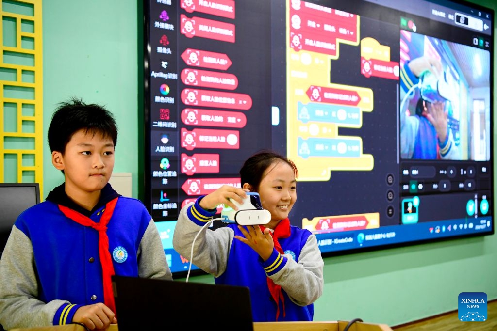 Students demonstrate an AI-powered simulation system for facial recognition at a primary school in Jinan, east China's Shandong Province, Oct. 27, 2026. In recent years, Jinan has strengthened science and technology education in primary and secondary schools. Through a rich array of regular sci-tech themed activities, local schools have deeply integrated scientific knowledge into daily teaching to better nurture students' scientific literacy. (Photo: Xinhua)
