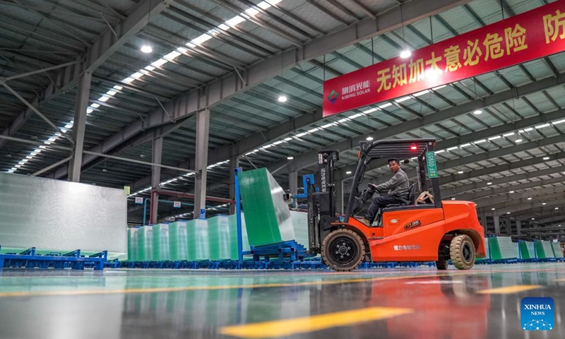 A staff member transports photovoltaic glass products in the workshop of Zhaotong Kibing Photovoltaic Technology Co,. Ltd. in Zhaotong City, southwest China's Yunnan Province, on Oct. 19, 2026. Leveraging its advantages in rich resources of silicon ore and the development of green electricity, Zhaotong City has attracted leading enterprises to develop the photovoltaic glass manufacturing industry, bringing about employment for surrounding residents. Currently, the city has basically formed an industrial chain from silicon mining and washing to the manufacturing of photovoltaic glass and photovoltaic modules. (Photo: Xinhua)