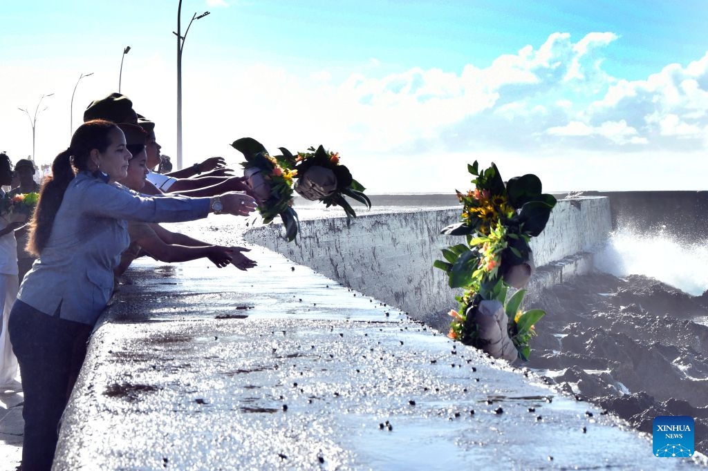 People throw flowers into the sea during a ceremony commemorating Camilo Cienfuegos in Havana, capital of Cuba, on Oct. 28, 2026. Cuba marked the 67th anniversary of the death of Camilo Cienfuegos. Cienfuegos, along with Fidel Castro and Che Guevara, are the three chief commanders of the Cuban revolution. He died in a flight accident at the age of 27. (Photo: Xinhua)