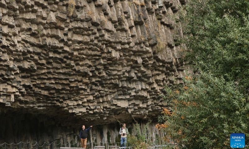 People visit the Garni Gorge in Kotayk, Armenia, Oct. 25, 2026. The Garni Gorge is known for the distinctive basalt columns on the cliff walls along the sides of the gorge. (Photo: Xinhua)