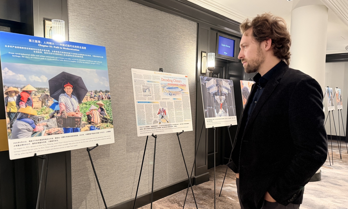 A guest visits the photo exhibition. Photo: Cao Siqi/GT