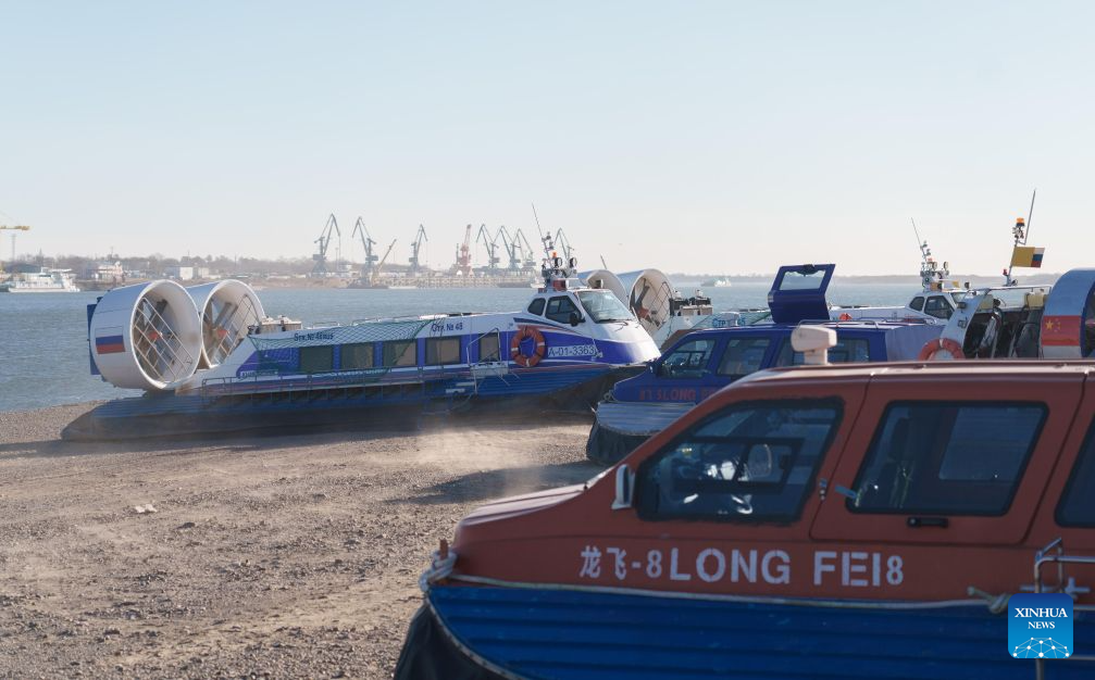 This photo taken on Oct. 27, 2026 shows Chinese and Russian hovercrafts at the hovercraft wharf of Heihe Port in northeast China's Heilongjiang Province. Heihe Port launched a seasonal hovercraft service to transport passengers between China and Russia on Tuesday. A one-way trip takes around two minutes. (Photo by Zhao Donglai/Xinhua)