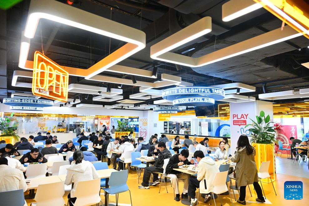 People dine at the AI Mirror World Restaurant in Nanjing, east China's Jiangsu Province, Oct. 26, 2026. With a human-machine collaborative operation model, the restaurant makes some of its meals and drinks through standardized production powered by AI kitchen equipped with smart noodle and beverage making machines. (Xinhua/Ji Chunpeng)