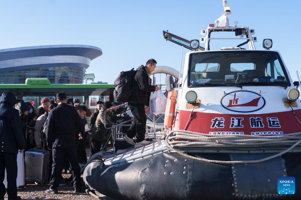 Outbound passengers board a hovercraft at the hovercraft wharf of Heihe Port in northeast China's Heilongjiang Province, Oct. 27, 2026. Heihe Port launched a seasonal hovercraft service to transport passengers between China and Russia on Tuesday. A one-way trip takes around two minutes. (Photo by Zhao Donglai/Xinhua)