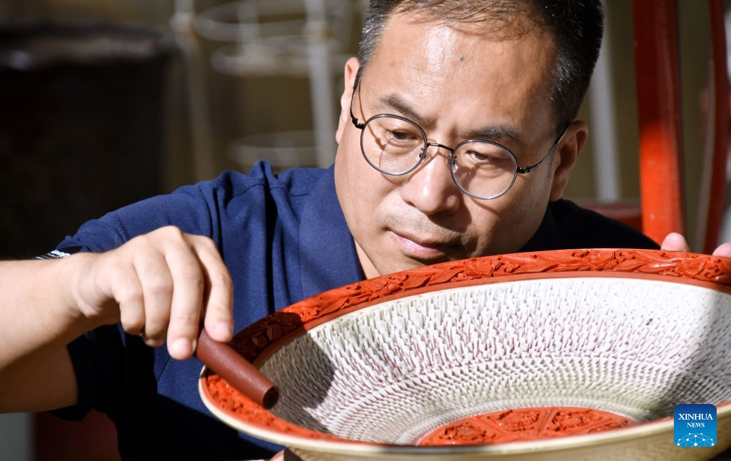 Zhu Jiang polishes a piece of work of the carved lacquer craft on porcelain body in Beijing, capital of China, Oct. 26, 2026.

Born in 1976, Zhu Jiang, a master of arts and crafts of Beijing, is an inheritor of the carved lacquer art.

The carved lacquer craft on porcelain body is a unique art form that combines two traditional Chinese crafts, porcelain and carved lacquerware making, into a single piece.

Through years of studying and practicing, Zhu has overcome a series of difficulties to achieve a better presentation of this craft. (Xinhua/Li Xin)