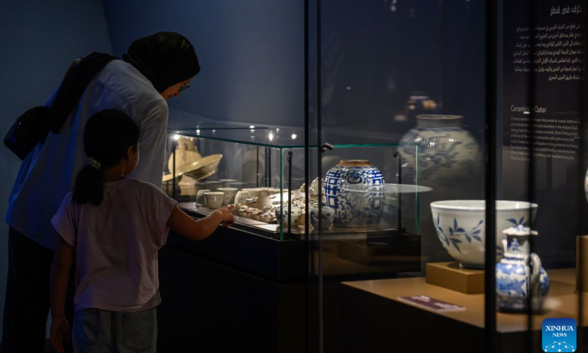 Visitors view ceramic artifacts at the exhibition Boats Floating Afar: The Maritime Trade of Ancient Chinese Ceramics at the National Museum of Qatar in Doha, Qatar, Oct. 29, 2026. (Photo by Nikku/Xinhua)