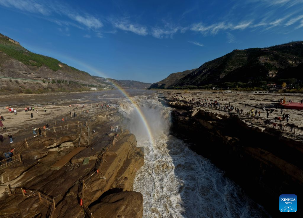 An aerial drone photo taken in Jixian County, north China's Shanxi Province, on Oct. 28, 2026, shows a rainbow over the Yellow River's Hukou Waterfall. (Photo by Lyu Guiming/Xinhua)