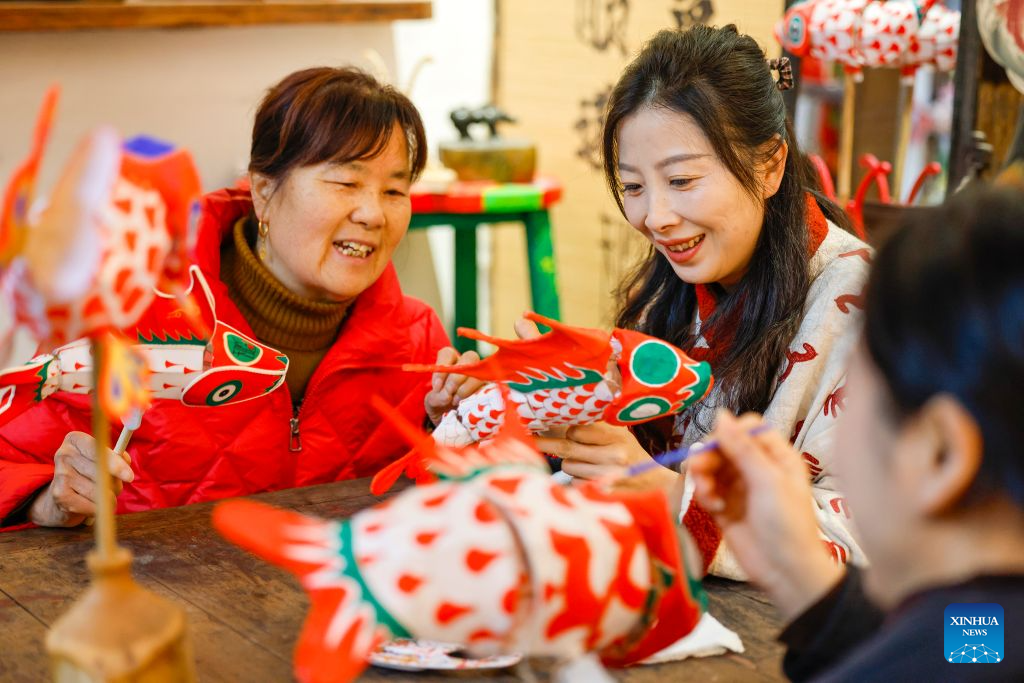 Elderly women learn to make fish-shaped lanterns at a studio in Shexian County of Huangshan City, east China's Anhui Province, Jan. 30, 2026. (Photo by Shi Yalei/Xinhua)