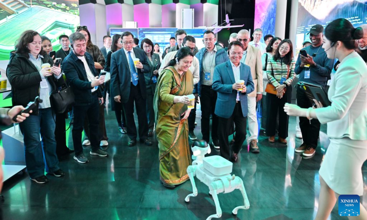 Participants of the 2026 Global Governance Forum (Xiong'an) interact with a robot dog while visiting a smart-city science and innovation center in Xiong'an New Area, north China's Hebei Province, Oct. 23, 2026. The 2026 Global Governance Forum (Xiong'an) kicked off here on Friday and will last till Sunday. Participants from various countries and regions visited a smart-city science and innovation center and the construction site of the start-up zone of Xiong'an New Area ahead of the forum. (Xinhua/Mu Yu)