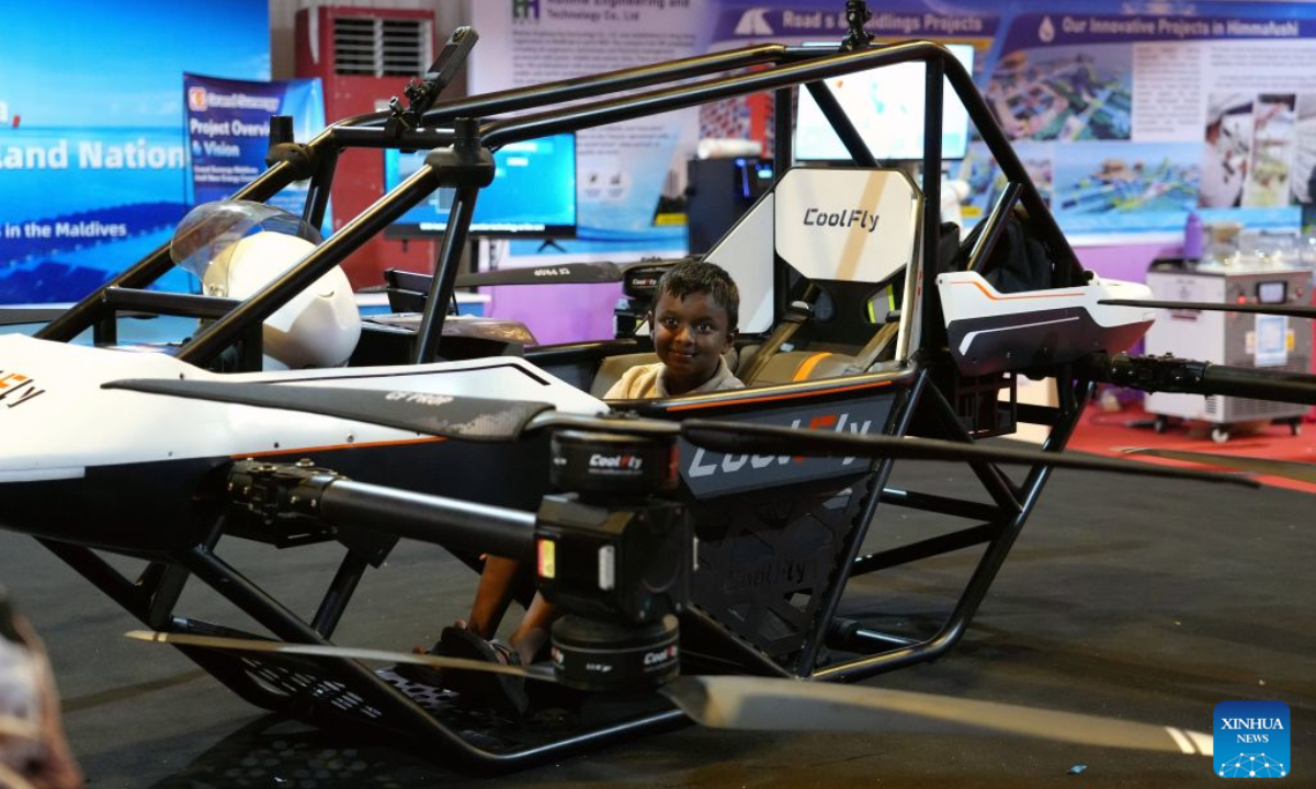 A teenager tries out a Chinese manned aerial vehicle at Maldives Expo 2026, in Male, Maldives, Oct. 27, 2026. The expo attracted approximately 430 exhibitors, showcasing more than 4,400 exhibits across seven themed exhibition zones. Twelve Chinese enterprises participated in the event, bringing new opportunities for Maldivian SMEs to enhance operational efficiency and expand international cooperation. (Xinhua/Xu Han)
