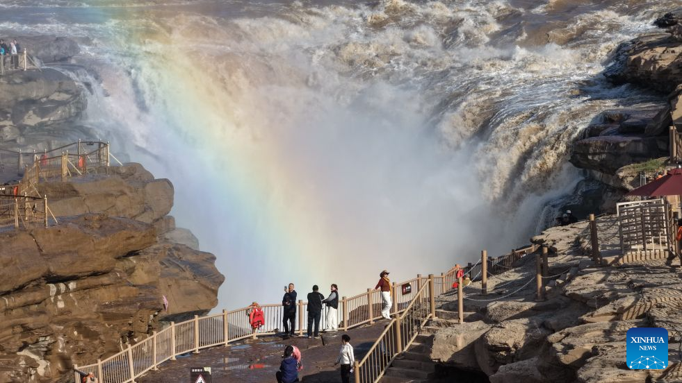 An aerial drone photo taken in Jixian County, north China's Shanxi Province, on Oct. 28, 2026, shows a rainbow over the Yellow River's Hukou Waterfall. (Photo by Lyu Guiming/Xinhua)