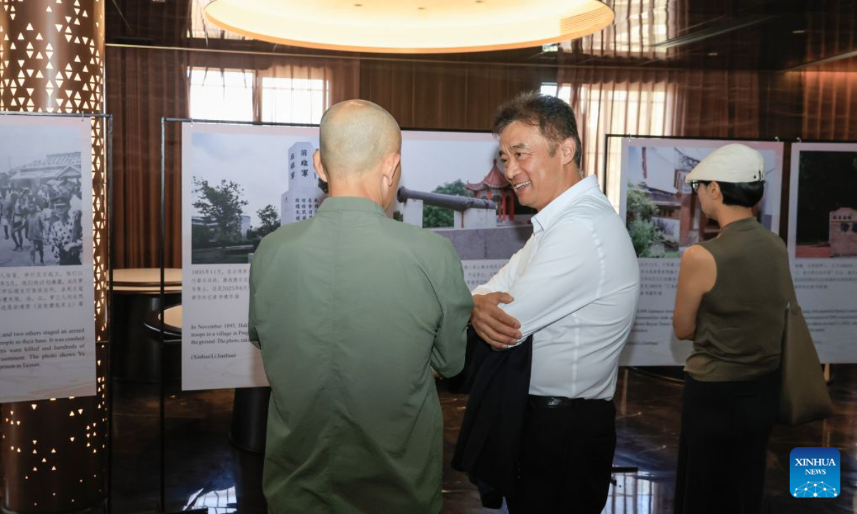People visit a photo exhibition marking the 81st anniversary of Taiwan's restoration to China, in Johannesburg, South Africa, Oct. 24, 2026. (Xinhua/Chen Wei)