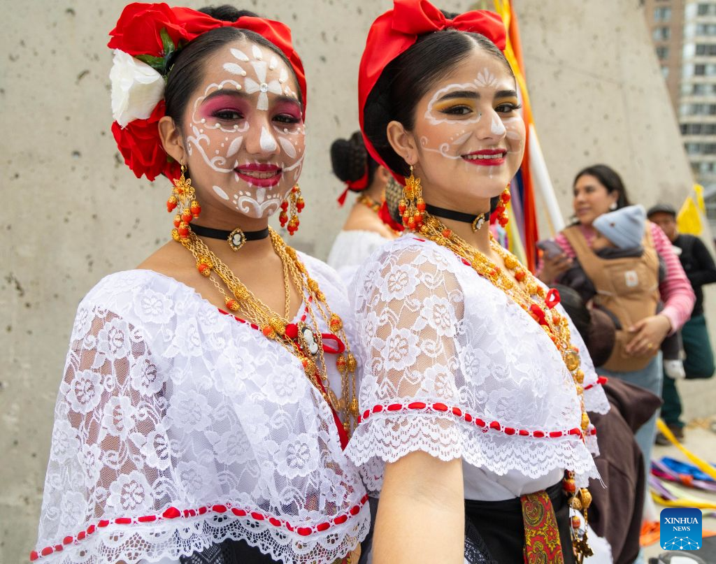 Dressed-up dancers pose for photos at Catrinas Festival Canada 2026 in Toronto, Canada, on Oct. 25, 2026. The annual Catrinas Festival was held here from Oct. 24 to 25, showcasing Mexican Day of the Dead (Día de Muertos) cultural traditions. (Photo by Zou Zheng/Xinhua)