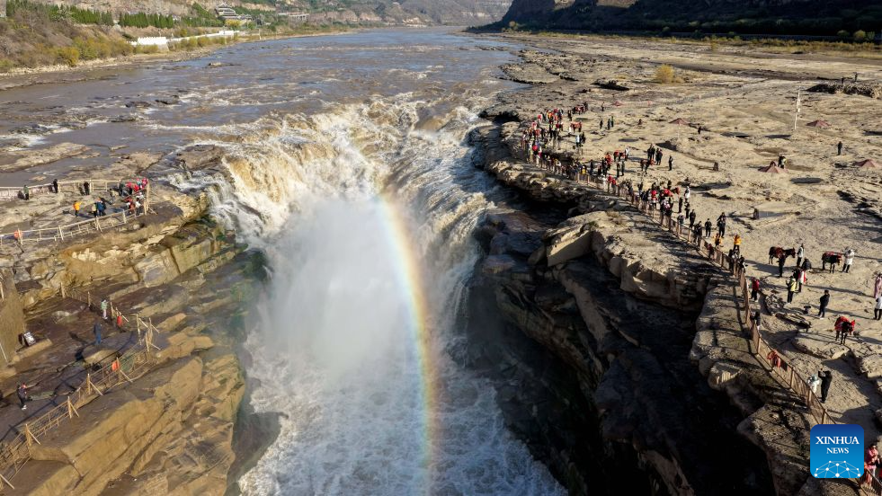 An aerial drone photo taken in Jixian County, north China's Shanxi Province, on Oct. 28, 2026, shows a rainbow over the Yellow River's Hukou Waterfall. (Photo by Lyu Guiming/Xinhua)