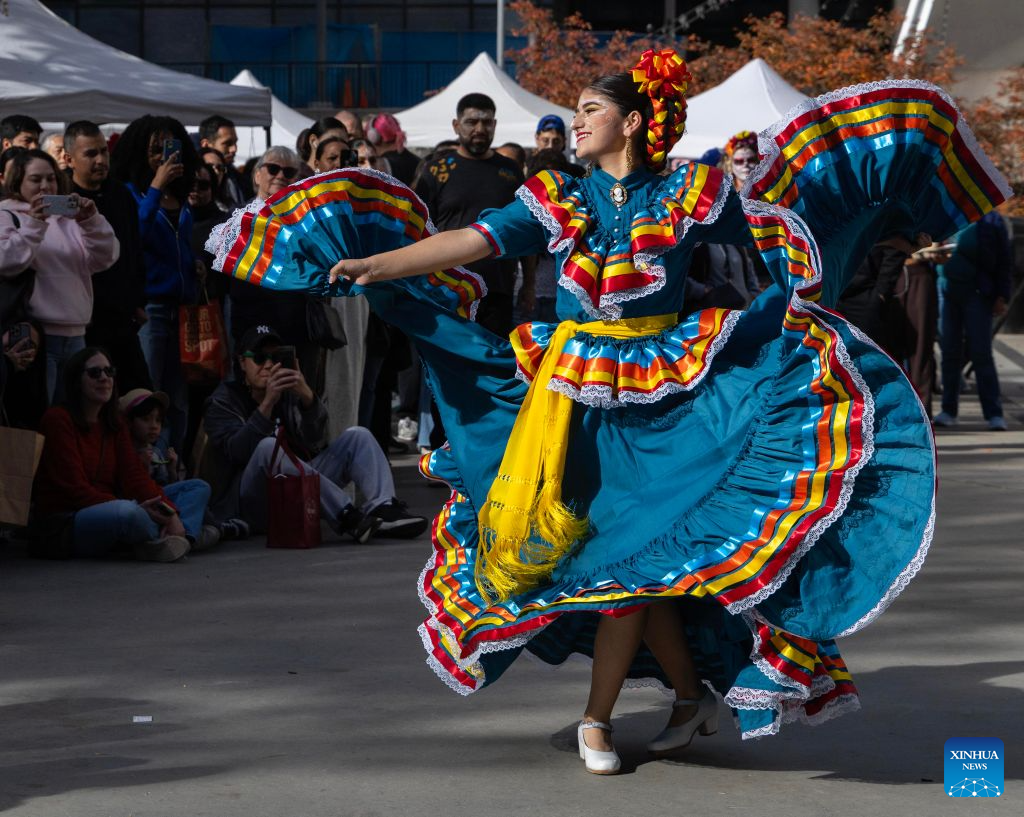 A dressed-up dancer performs traditional Mexican folk dance at Catrinas Festival Canada 2026 in Toronto, Canada, on Oct. 25, 2026. The annual Catrinas Festival was held here from Oct. 24 to 25, showcasing Mexican Day of the Dead (Día de Muertos) cultural traditions. (Photo by Zou Zheng/Xinhua)