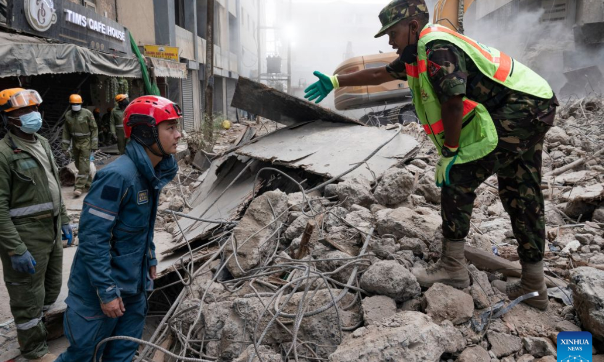 A Chinese rescuer (2nd R) communicates with a local rescuer at the site of a building collapse in Eastleigh, Nairobi, Kenya, on Oct. 27, 2026. (Xinhua/Xie Jianfei)