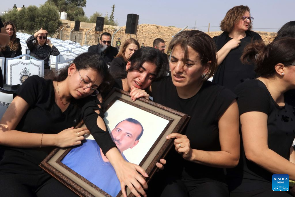 People attend a funeral of victims of a church shooting in Karak, Jordan, Oct. 25, 2026. Thousands of mourners gathered on Sunday for the funeral of victims of a terrorist attack targeting a church in Jordan's southern Karak Governorate, which claimed nine lives. (Photo by Mohammad Abu Ghosh/Xinhua)