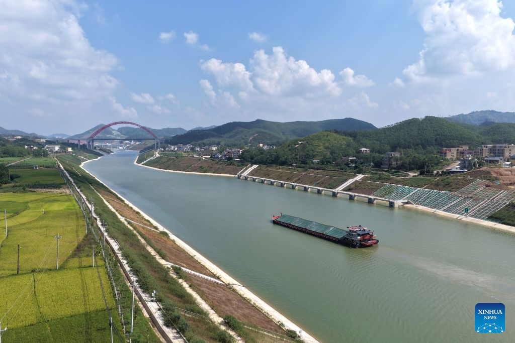 An aerial drone photo taken on Oct. 21, 2026 shows a cargo vessel near the Jiuzhou bridge over the Pinglu Canal in south China's Guangxi Zhuang Autonomous Region. Cargo throughput of the Pinglu Canal has surpassed 1 million tonnes since its opening to navigation on Sept. 16.

The 134.2-kilometer canal runs from Nanning, capital of south China's Guangxi Zhuang Autonomous Region, to the Beibu Gulf, the closest maritime outlet for much of southwest China.

The canal stretches along the New International Land-Sea Trade Corridor, a strategic trade route connecting China's inland regions with ASEAN and other global markets. It is the first river-to-sea canal project planned and coordinated at the national level since the founding of the People's Republic of China in 1949. (Xinhua/Zhou Hua)