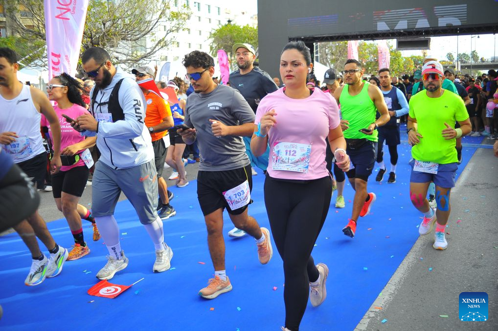 Participants run in a charity marathon dedicated to the fight against cancer, in Tunis, Tunisia, Oct. 25, 2026. October is observed globally as Breast Cancer Awareness Month. In Tunis, a charity marathon was held to encourage the public to engage in physical exercise and take proactive steps toward cancer prevention and control. According to the Tunis Afrique Presse (TAP), hundreds of people took part in the event. (Photo by Adel Ezzine/Xinhua)