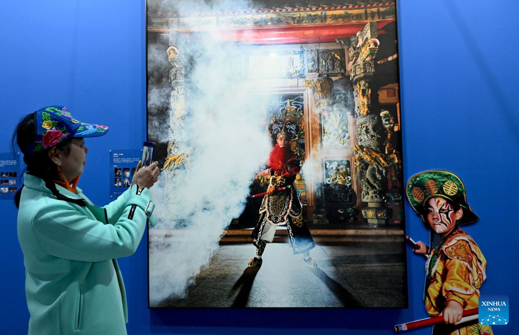 A visitor takes photos at an exhibition during the 16th China Photography Festival in Sanmenxia City, central China's Henan Province, Oct. 29, 2026. The 16th China Photography Festival kicked off here on Thursday, featuring exhibitions covering a variety of themes, including documentary and art. (Xinhua/Zhu Xiang)
