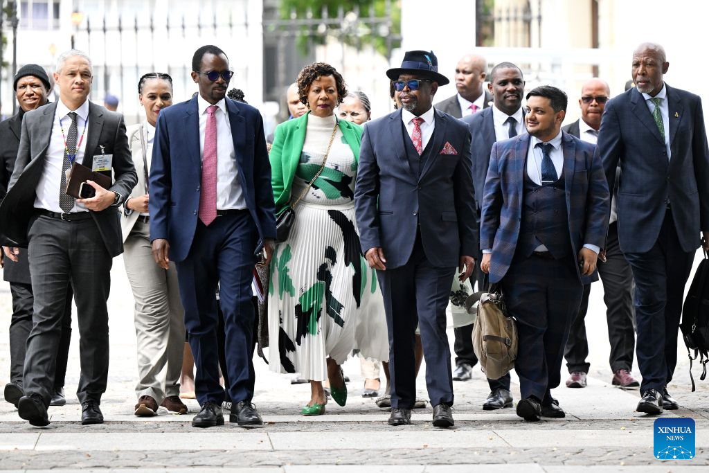 South African Finance Minister Enoch Godongwana (3rd R, front) arrives at the Parliament to deliver the Medium-Term Budget Policy Statement in Cape Town, South Africa, Oct. 21, 2026. South Africa has lowered its economic growth forecast for 2026 to 1.2 percent and announced temporary fuel levy cuts to ease cost-of-living pressures, Finance Minister Enoch Godongwana said on Wednesday.(Photo by Xabiso Mkhabela/Xinhua)