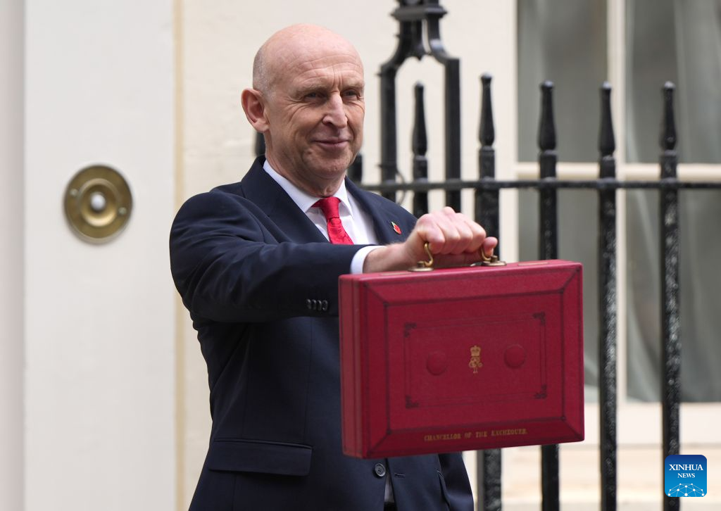 British Chancellor of the Exchequer John Healey shows to the media the iconic red box that contains the Budget 2026 speech outside 11 Downing Street in London, Britain, Oct. 28, 2026. Britain would provide 10 billion pounds (13 billion U.S. dollars) of additional economic and military support to Ukraine, said British Chancellor of the Exchequer John Healey on Wednesday. (Xinhua/Zhang Feng)
