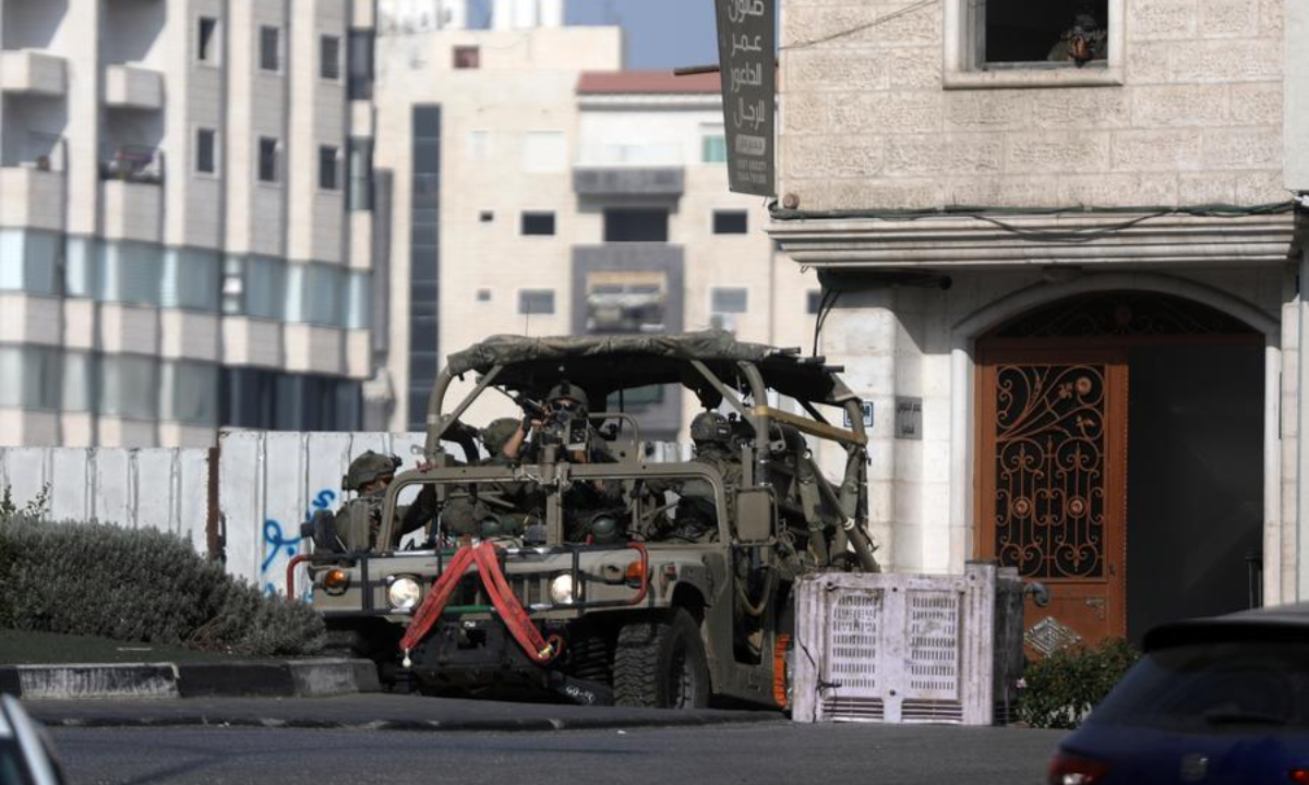 An Israeli military vehicle patrols during a military operation in the West Bank city of Hebron, on Oct. 25, 2026. (Photo by Mamoun Wazwaz/Xinhua)