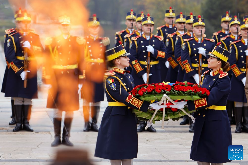 Soldiers of an honor guard carry a flowers wreath during a ceremony marking Romania's Army Day at the Tomb of the Unknown Soldier in Bucharest in Bucharest, Romania, Oct. 25, 2026. (Photo by Cristian Cristel/Xinhua)