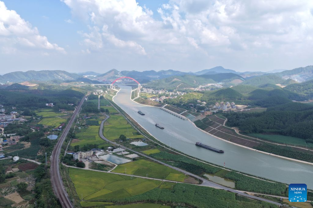 An aerial drone photo taken on Oct. 21, 2026 shows cargo vessels near the Jiuzhou bridge over the Pinglu Canal in south China's Guangxi Zhuang Autonomous Region. Cargo throughput of the Pinglu Canal has surpassed 1 million tonnes since its opening to navigation on Sept. 16.

The 134.2-kilometer canal runs from Nanning, capital of south China's Guangxi Zhuang Autonomous Region, to the Beibu Gulf, the closest maritime outlet for much of southwest China.

The canal stretches along the New International Land-Sea Trade Corridor, a strategic trade route connecting China's inland regions with ASEAN and other global markets. It is the first river-to-sea canal project planned and coordinated at the national level since the founding of the People's Republic of China in 1949. (Xinhua/Zhou Hua)

