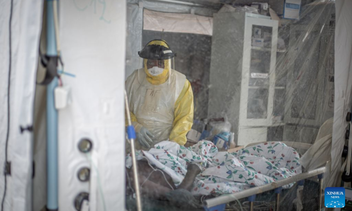 A medical worker checks an infected patient at an Ebola treatment center in Bunia, capital of Ituri Province in the Democratic Republic of the Congo (DRC), on Oct. 18, 2026. The Africa Centers for Disease Control and Prevention (Africa CDC) has called for greater global solidarity and international support to contain the rapidly expanding Bundibugyo Ebola outbreak. (Xinhua)