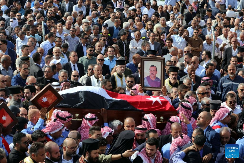 People attend a funeral of victims of a church shooting in Karak, Jordan, Oct. 25, 2026. Thousands of mourners gathered on Sunday for the funeral of victims of a terrorist attack targeting a church in Jordan's southern Karak Governorate, which claimed nine lives. (Photo by Mohammad Abu Ghosh/Xinhua)