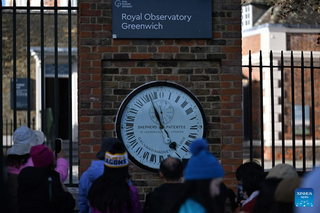 Visitors watch the Shepherd Gate Clock at the entrance to the Royal Observatory in Greenwich, London, Britain, on Oct. 25, 2026. The clock was the world's first to display Greenwich Mean Time (GMT) directly to the public and features a 24-hour dial. Britain ended British Summer Time (BST) at 2am on Sunday, October 25, 2026, setting clocks back one hour to Greenwich Mean Time (GMT). (Xinhua/Li Mangmang)