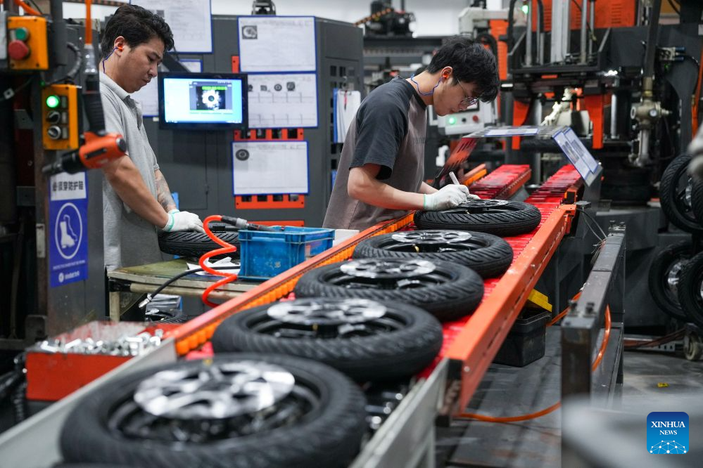 Workers operate at a tire assembly line at a smart electric two-wheeler company in Changzhou, east China's Jiangsu Province, Oct. 14, 2026.
In recent years, Changzhou City has leveraged its traditional strengths in manufacturing to accelerate the clustering of electric two-wheeler manufacturers and their component suppliers, aiming at development of more smart and high-end products.
The city now accounts for about 10 percent of China's output of electric two-wheelers and has established a complete industrial chain spanning from parts to general assembly.
Changzhou has also actively reinforced the technological innovation as the main driver of the industry, as local makers keep boosting R&D efforts to further improve their products. (Xinhua/Li Bo)