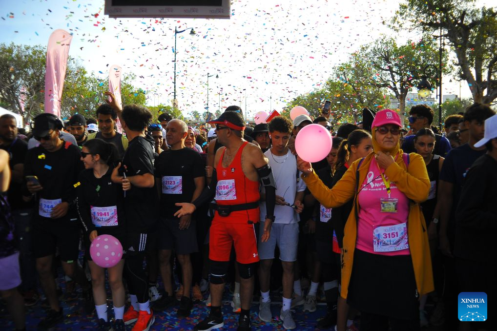 People take part in a charity marathon dedicated to the fight against cancer, in Tunis, Tunisia, Oct. 25, 2026. October is observed globally as Breast Cancer Awareness Month. In Tunis, a charity marathon was held to encourage the public to engage in physical exercise and take proactive steps toward cancer prevention and control. According to the Tunis Afrique Presse (TAP), hundreds of people took part in the event. (Photo by Adel Ezzine/Xinhua)