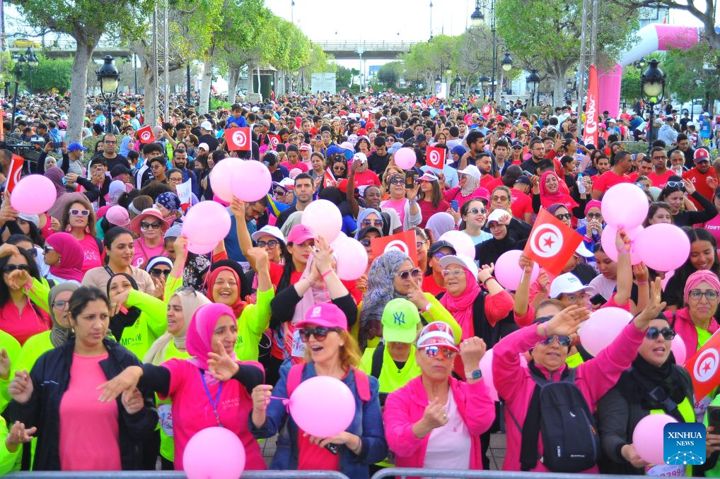 People take part in a charity marathon dedicated to the fight against cancer, in Tunis, Tunisia, Oct. 25, 2026. October is observed globally as Breast Cancer Awareness Month. In Tunis, a charity marathon was held to encourage the public to engage in physical exercise and take proactive steps toward cancer prevention and control. According to the Tunis Afrique Presse (TAP), hundreds of people took part in the event. (Photo by Adel Ezzine/Xinhua)