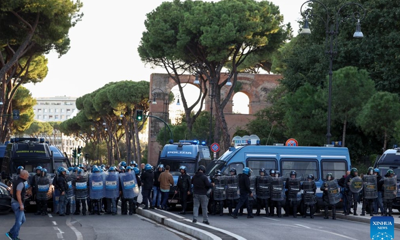 Police stand guard near Circo Massimo for an anti-war march in Rome, Italy, Oct. 24, 2026. Protests over rising living costs, military expansion and increased arms spending swept across several Italian cities on Saturday, with clashes between demonstrators and police reported in multiple locations. In Rome, demonstrators set off from Piazza della Repubblica, according to the ANSA news agency. Clashes erupted between protesters and police in the city center later in the evening, prompting police to use water cannons and tear gas in an attempt to disperse the crowds. (Xinhua/Wang Kaiyan)