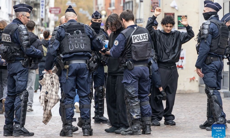 Security personnel work on the street in Lille, France, Oct. 24, 2026. Around 410,000 people took part in a new round of protests across France on Saturday, French news channel BFM TV reported, citing the Interior Ministry. (Photo by Sebastien Courdji/Xinhua)