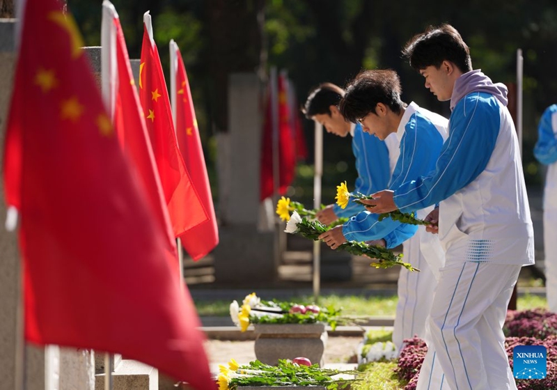 Students presents flowers to martyrs of the Chinese People's Volunteers (CPV) during a commemorative activity, marking the 76th anniversary of the CPV's entering the Democratic People's Republic of Korea to fight in the War to Resist U.S. Aggression and Aid Korea, at the CPV martyrs' cemetery in Shenyang, northeast China's Liaoning Province, Oct. 25, 2026. The event was held here on Sunday. (Xinhua/Li Gang)