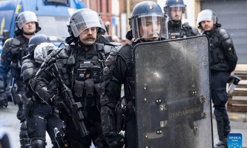 Security personnel work on the street in Lille, France, Oct. 24, 2026. Around 410,000 people took part in a new round of protests across France on Saturday, French news channel BFM TV reported, citing the Interior Ministry. (Photo by Sebastien Courdji/Xinhua)