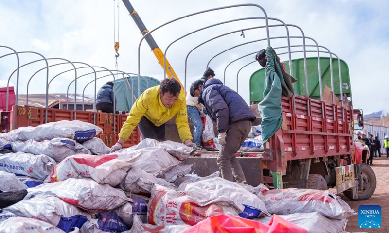 Staff members transfer coal for heating at a quake-hit village in Maru Township of Baqen County, Nagqu City, southwest China's Xizang Autonomous Region, Oct. 24, 2026. As of 11 a.m. Saturday, 52,450 items or sets of disaster relief supplies had been sent to the quake zone, while more than 2,500 rescue personnel were engaged in relief operations.
Authorities have established 35 temporary resettlement sites in the disaster zone. Medical treatment and public health and epidemic prevention efforts are proceeding in an orderly manner, according to the local emergency command headquarters. (Xinhua/Tenzin Nyida)