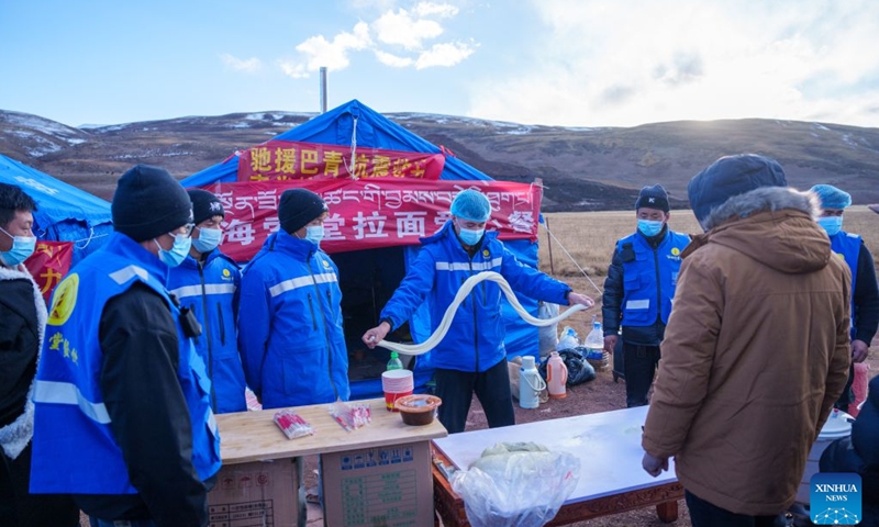 A volunteer makes noodles at a quake-hit village in Maru Township of Baqen County, Nagqu City, southwest China's Xizang Autonomous Region, Oct. 24, 2026. As of 11 a.m. Saturday, 52,450 items or sets of disaster relief supplies had been sent to the quake zone, while more than 2,500 rescue personnel were engaged in relief operations. Authorities have established 35 temporary resettlement sites in the disaster zone. Medical treatment and public health and epidemic prevention efforts are proceeding in an orderly manner, according to the local emergency command headquarters. (Xinhua/Tenzin Nyida)