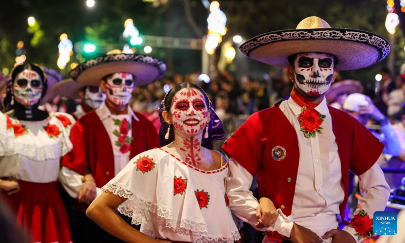 People take part in the Catrinas Parade in Mexico City, capital of Mexico, Oct. 25, 2026. The Catrinas Parade was held on Sunday ahead of the Day of the Dead. (Xinhua/Ding Hongfa)