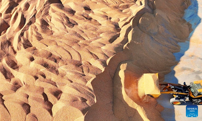 A drone photo taken on Oct. 24, 2026 shows a shovel loader transferring the dried corn at a farm under Beidahuang Group in northeast China's Heilongjiang Province. With the autumn harvest drawing to an end in Heilongjiang, China's top grain-producing province, all grain-growing areas in the province are stepping up post-harvest management to ensure safe grain storage and procurement. (Photo by Lu Wenxiang/Xinhua)